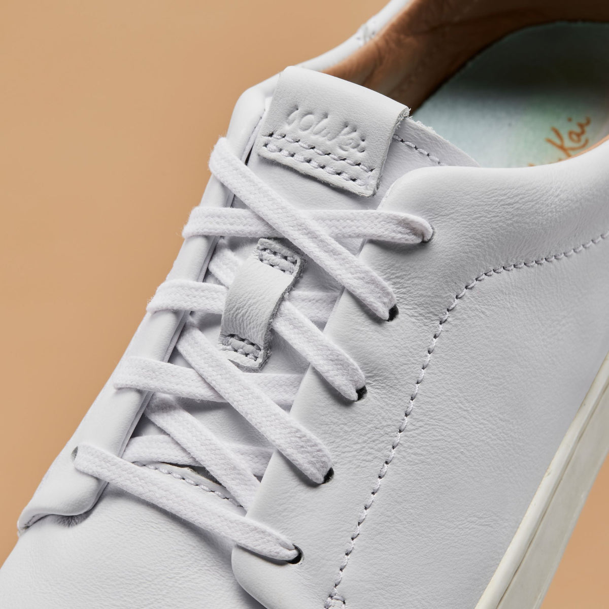 OluKai New | Pehuea Lī ‘Ili Women's Leather Sneakers - White